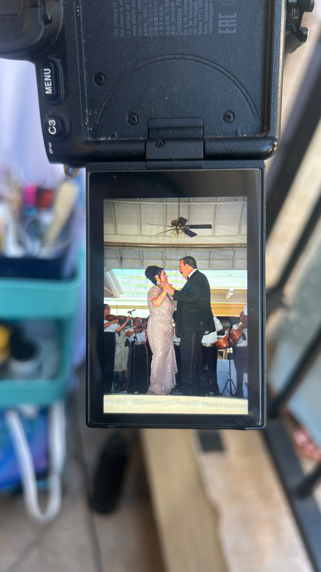 A camera screen showing the anniversary couple dancing in front of mariachi musicians