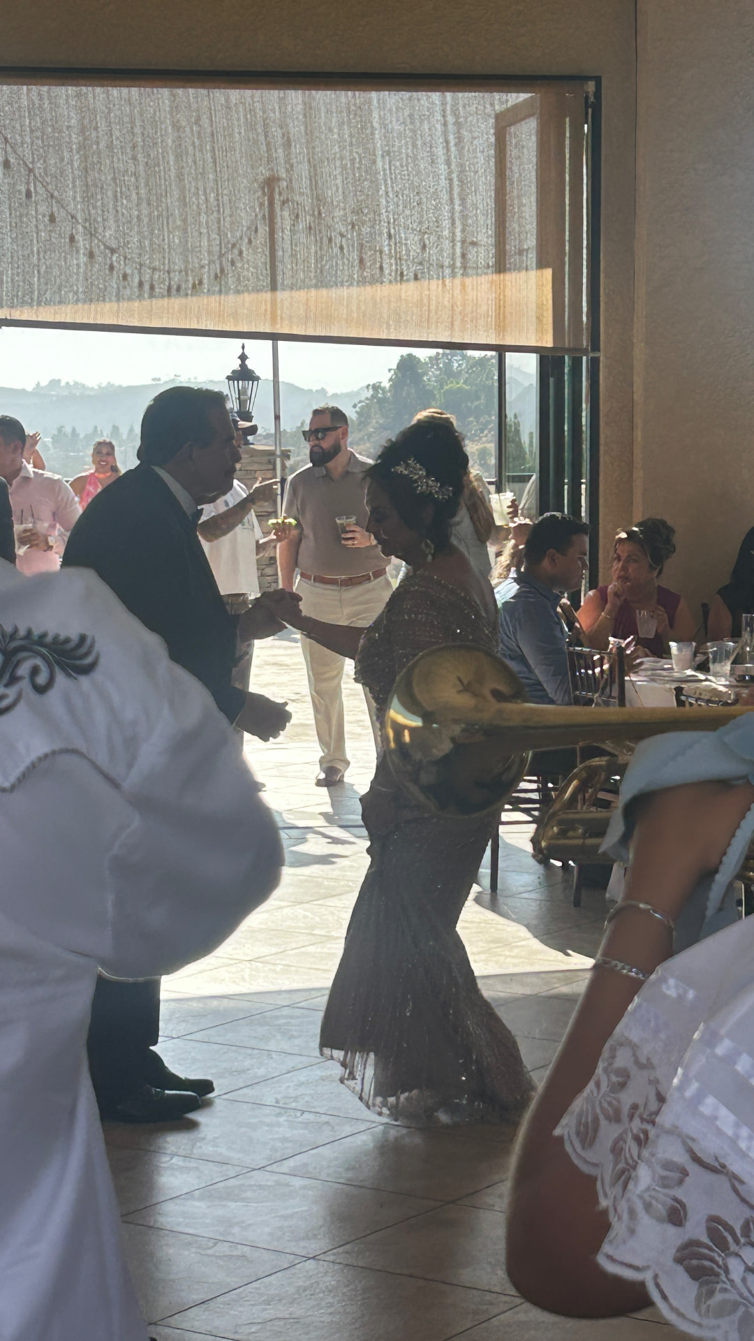 Guests dancing together at a golden-hour anniversary celebration