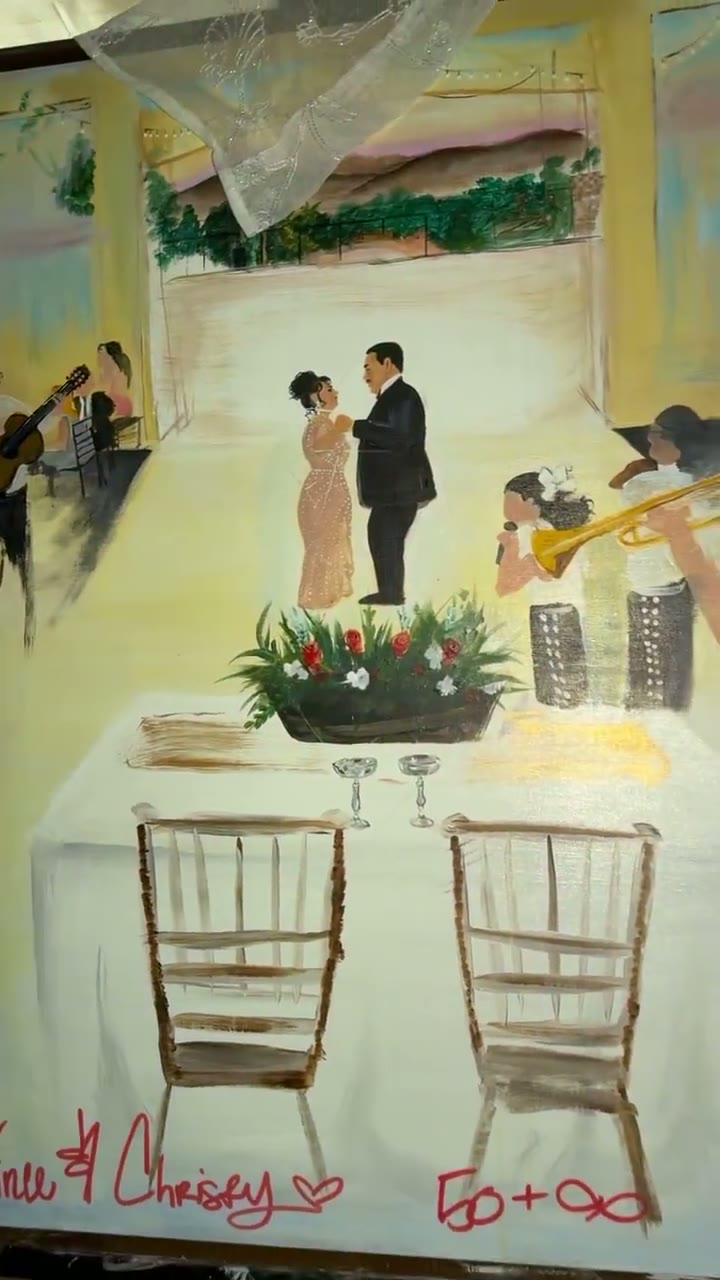Chaleuh lifting a sheer veil to reveal the finished anniversary painting