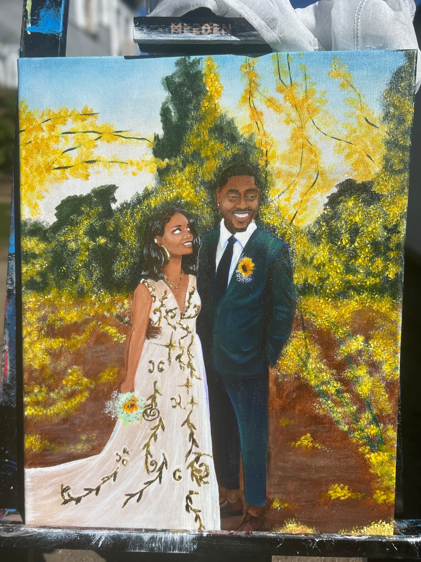 Acrylic painting of the bride and groom beneath golden blossoms, the gown traced in gold vines